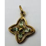 A 9ct gold green and yellow sapphire in an openwork four pointed star design. Gross weight