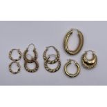 A selection of gold creole earrings comprising three pairs of 9ct gold earrings, two odd 9ct gold