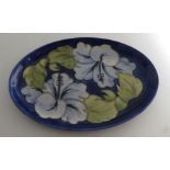 Moorcroft oval plate decorated with the hibiscus pattern, Moorcroft marks to the base 23cm x 15.5cm.