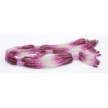 A tassel necklet of ruby, pink sapphire and white sapphire rondelle beads, with a yellow metal