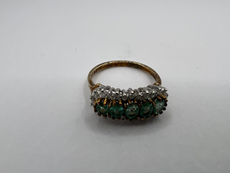 A diamond and emerald cluster ring in 9ct gold. Gross weight approximately 2.9 grams. Size N. (1)