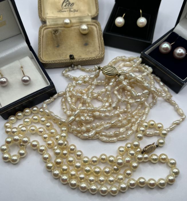 A selection of cultured pearl and 9ct gold jewellery comprising of four pairs of earrings (one as