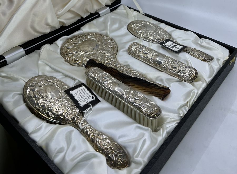 Two cased 1970s sterling silver hairbrush vanity sets by Broadway, in leather cases, comprising hair