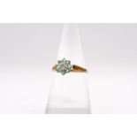 A diamond and emerald cluster ring in 9ct gold. Gross weight approximately 1.3 grams. Size N. (1)