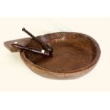 An 18th century elm treen dairy bowl; a later fruitwood masher; another mahogany similar (3)