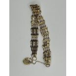 A 9ct gold gate bracelet with a heart padlock clasp and safety chain. Gross weight approximately 5.1