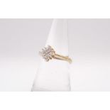 A 9ct gold diamond cluster ring. Gross weight approximately 2.9 grams, Size N.