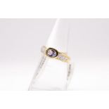 A 9ct gold bezel set tanzanite and white diamond dress ring. Gross weight approximately 3 grams.