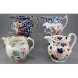 Two early nineteenth century blue and white transfer-printed jugs, a printed and painted jug and a