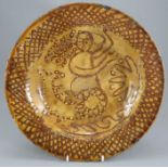 A late eighteenth, early nineteenth century slipware circular dish in the manner of Thomas Toft,