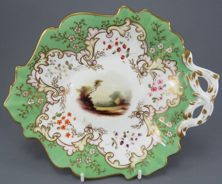 A mid-nineteenth century porcelain hand-painted Alcock handled dessert dish, c. 1830-50.  It is