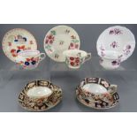 A group of early nineteenth century hand-painted porcelain cups and saucers, c. 1820-40. To include: