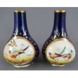 A pair of early nineteenth century Derby porcelain vases, c. 1820. Each has central vignette with