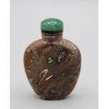 Chinese snuff bottle. Puddingstone of flattened shield shape supported on a raised foot, the
