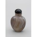 Chinese snuff bottle. Fine thumb print agate of compressed ovoid form supported on a small raised