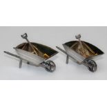 A pair of heavy gauge silver and silver gilt novelty wheelbarrow salts with matching shovels,