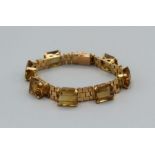 A citrine set heavy gauge yellow metal bracelet, KEE test indicates region of 15-18ct, gross