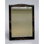 An early 20th century black lacquer painted and Chinoiserie decorated toilet mirror, with