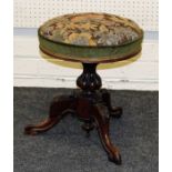 A Victorian rosewood piano stool, floral and green plush upholstered circular adjustable seat, on