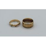A pair of 9ct decorative band rings, one a thick band with star engraving, the other a wire