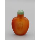 Chinese snuff bottle. Carnelian of shield form tapering to an oval base, the stone of an even rich