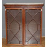 An Edwardian mahogany, box strung wall mounting bookcase, the moulded cornice over a pair of