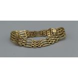 A yellow metal gate bracelet weighing approximately 17.6gm