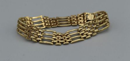 A yellow metal gate bracelet weighing approximately 17.6gm