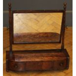 A William IV mahogany toilet mirror, the adjustable rectangular plate within turned and block horns,