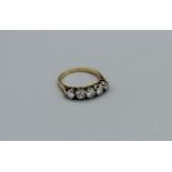 A five stone diamond half hoop ring, estimated 1ct total diamond weight in unmarked yellow metal,