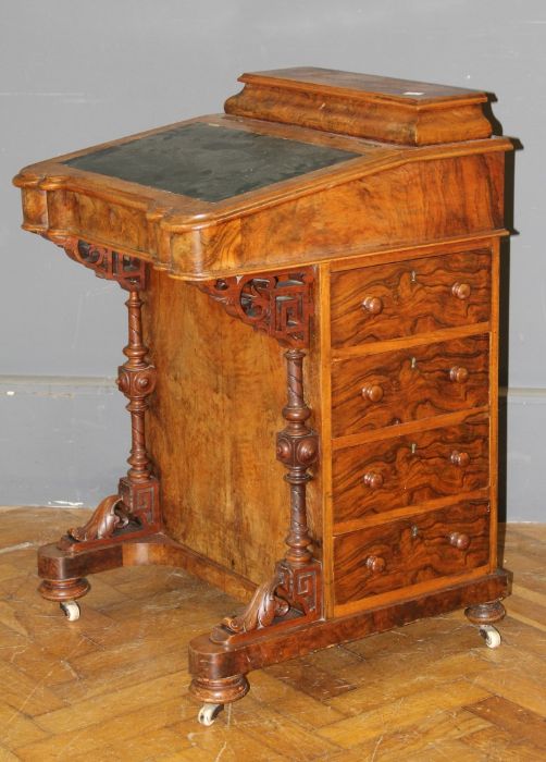 A Victorian walnut, florally boxwood strung Davenport desk, with covered stationary compartment