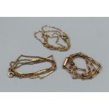 Three chains. A curb and bar 9ct chain (hallmarked), approximate weight 3.6gm, along with a 16
