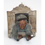 An early 20th century Austrian terracotta relief plaque, modelled as an elderly gentleman leaning