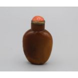 Chinese snuff bottle. Quartzite of flattened ovoid form resting on an oval foot, lightly incised