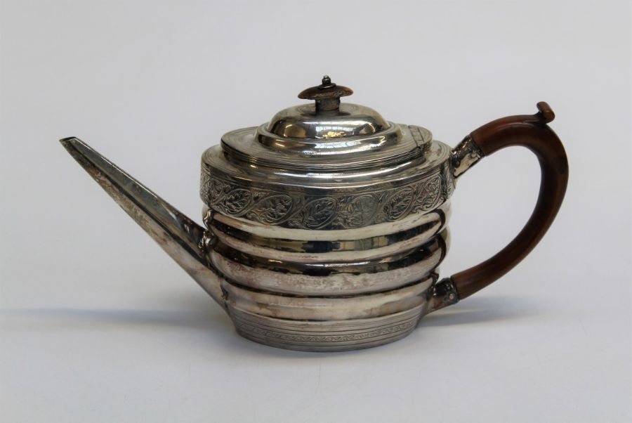 Solomon Houghman, a George III silver teapot of ribbed oval form, engraved with leafy bands around