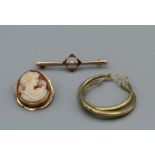 A selection of yellow metal jewellery, comprising a cameo brooch/pendant, a pair of 9ct creole
