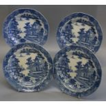 Four early 19th century blue and white pottery indented circular plates, printed in Chinoiserie