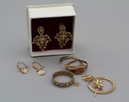 A collection of 9ct and yellow metal jewellery comprising two rings and four pairs of earrings,
