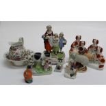 A quantity of Staffordshire flatback figures and other decorative ceramics including a stirrup cup