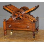 A mid 19th century rosewood Canterbury, three division cross frame supports over single drawer