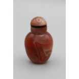 Chinese snuff bottle. Carnelian agate of compressed ovoid shape with striking red and grey