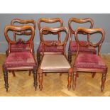 A set of six mid Victorian mahogany balloon back chairs raised on turned legs