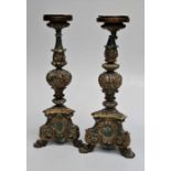 A pair of 18th century Italian carved wood parcel gilt candle stands, each with knopped column,