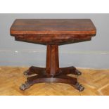 An early Victorian rosewood and crossbanded card table carried on a faceted column, raised on a