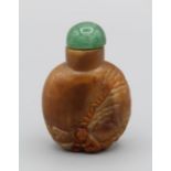 Chinese snuff bottle. Quartzite of flattened rounded form, carved in relief using reddish layer in