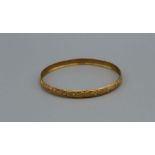 A yellow metal bangle, in the Indian style. Gross weight approximately 7.6gm, tests with KEE