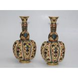 Zsolnay, Pecs, a pair of early 20th century reticulated vases of bombe onion form, decorated in