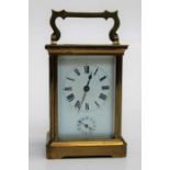An early 20th brass, five glass carriage alarm clock, the eight day movement striking upon a bell,