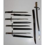 A French 1874 pattern bayonet in metal scabbard, a Finnish bayonet stamped Hackman and co, two