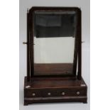 A 19th century mahogany toilet mirror, the cushion framed bevelled plate with moulded gilt slip,